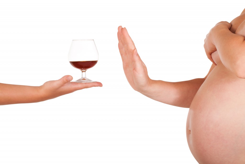 Pregnant woman rejects of taking glass of brandy.