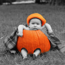 Im Kürbis sitzendes Baby an Halloween